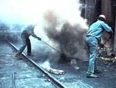 	Workers on top of a coke oven. Work on top of coke ovens is known to cause lung and skin cancer, and thought to cause kidney cancer.